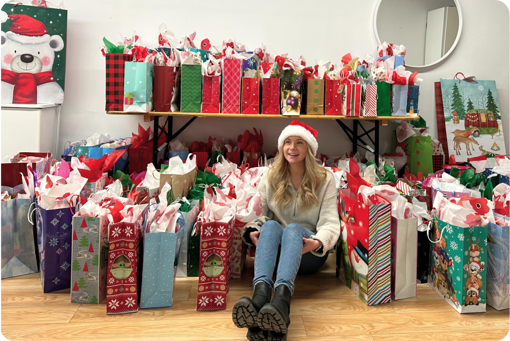Paisley Nyberg surrounded by gift bags